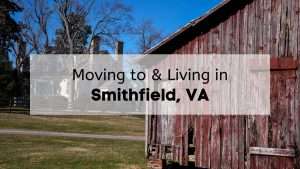 Two farm buildings at Windsor Castle Park in Smithfield, VA, on a sunny day, with the text, "Moving to & Living in Smithfield VA," overlaid