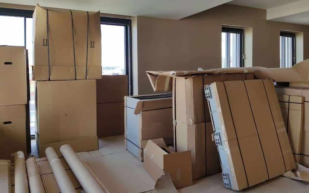 Packed furniture and boxes from a Kitty Hawk moving company in an apartment